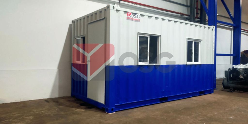 A portable container office with windows and blue trim.
