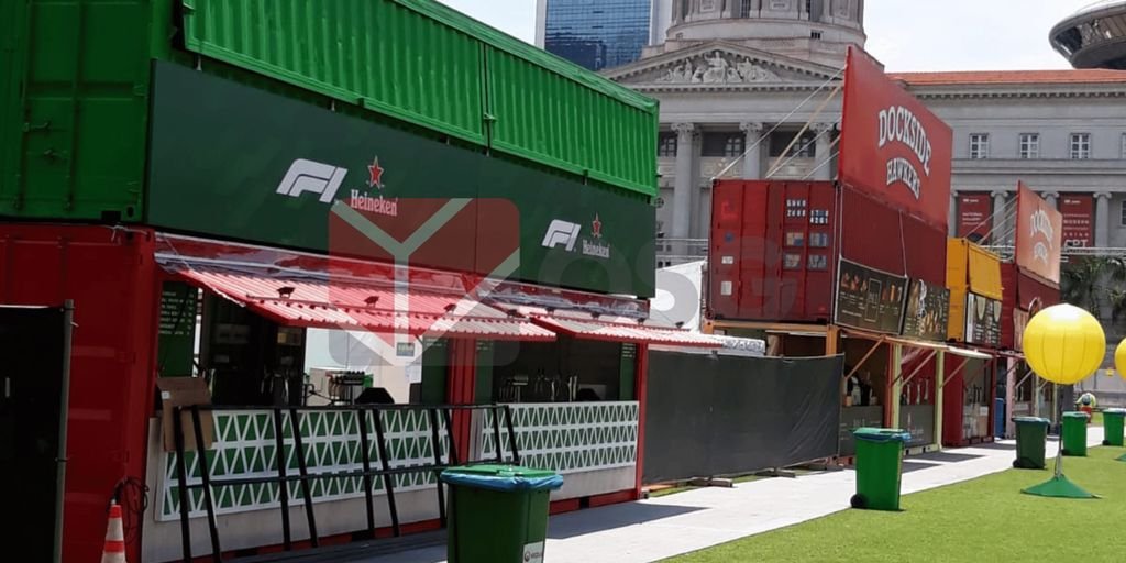 Colorful shipping containers set up for an outdoor event.