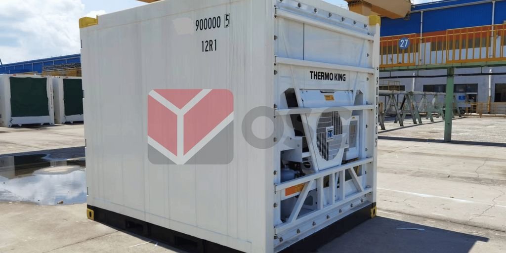 Refrigerated container with industrial branding in a storage area.