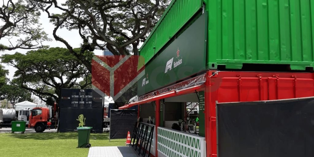 Colorful shipping containers set up in an outdoor event space.