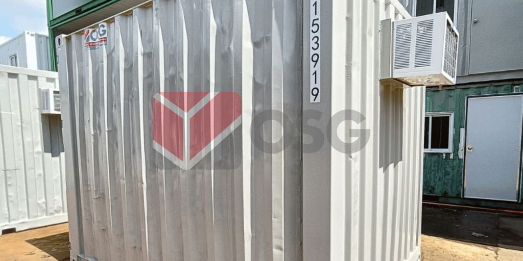 A white shipping container with an air conditioning unit attached.