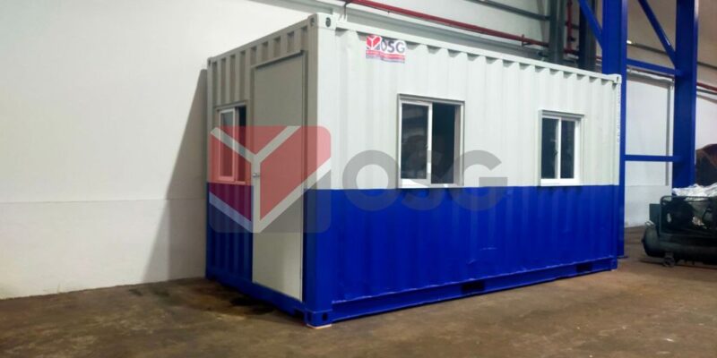 A blue and white shipping container converted into an office.