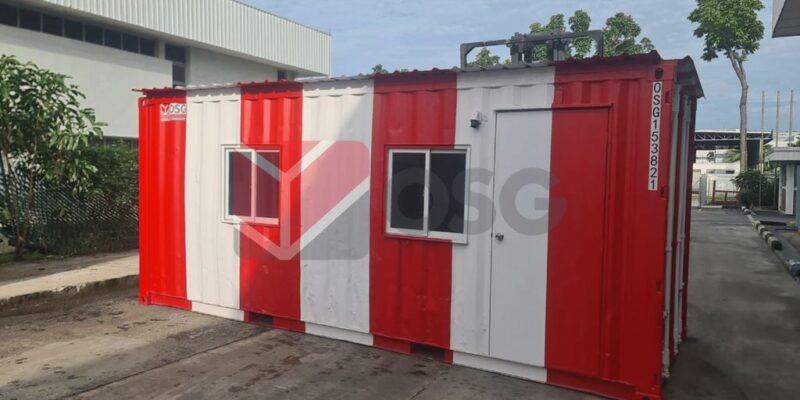 A red and white shipping container with windows.