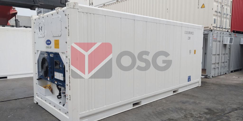 White shipping container with equipment, positioned on a dock.