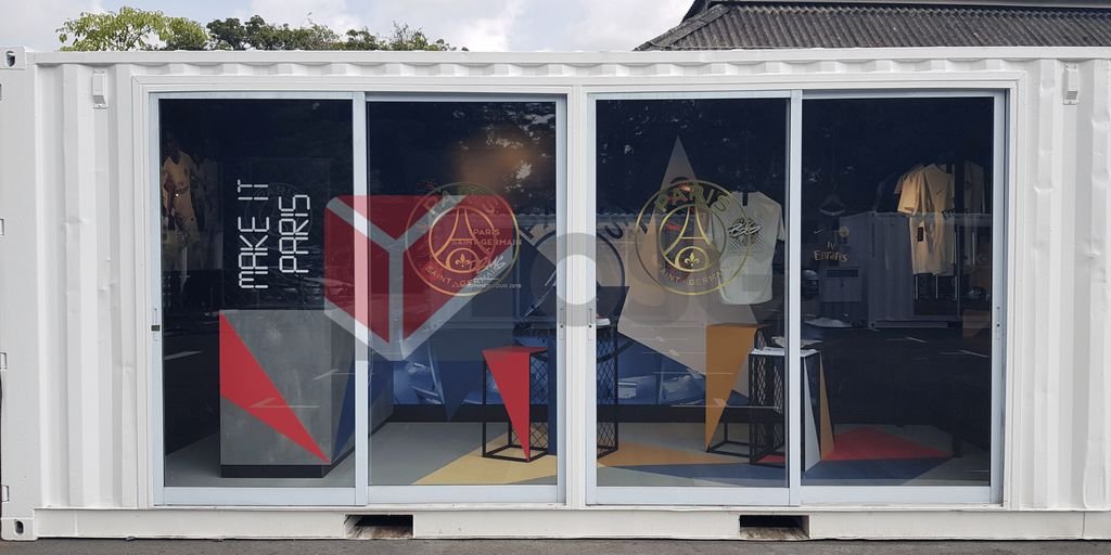 Colorful display inside a shipping container with geometric designs.