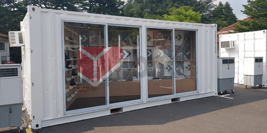 A shipping container store displaying shoes and clothing.
