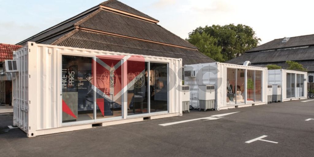 Modern shipping containers converted into retail spaces in a street.