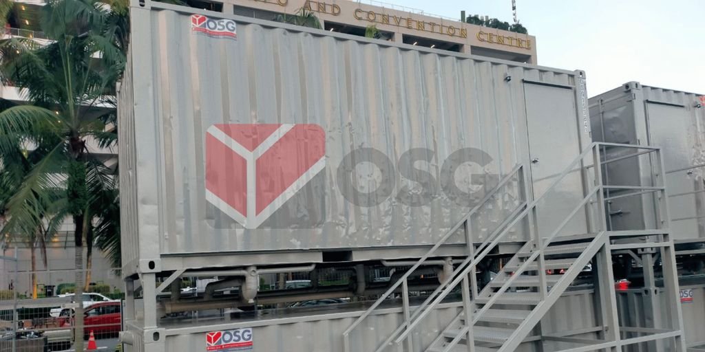 Metal shipping containers with steps outside a convention center.