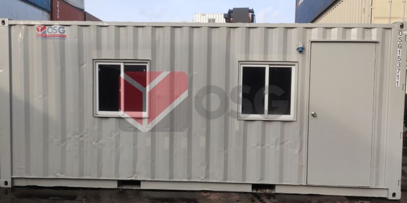 A shipping container with two windows and a door.