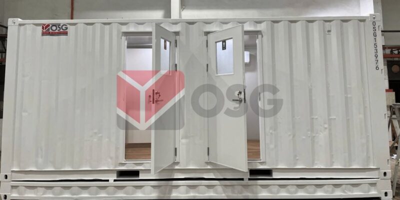 White shipping container with double doors, minimalist interior design.