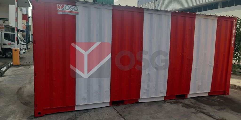 Red and white shipping container in an urban setting.