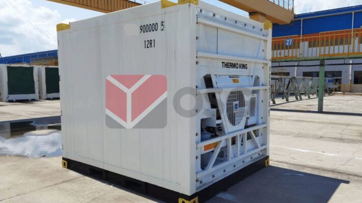 Refrigerated container with industrial branding in a storage area.