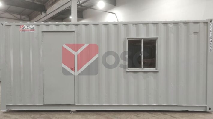 Gray shipping container with a door and a small window.