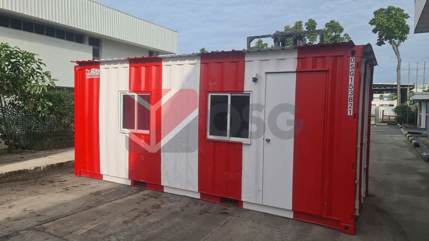 A red and white shipping container with windows.