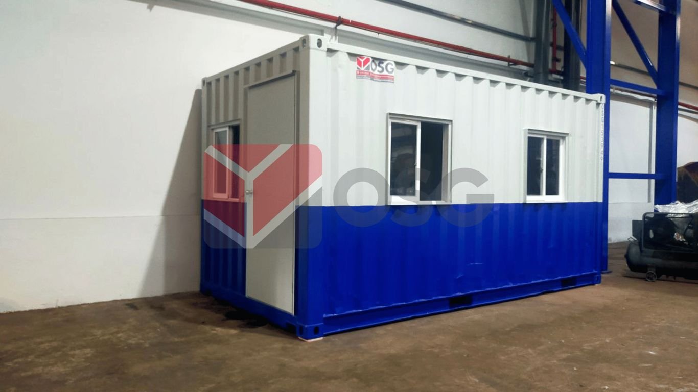 A portable container office with windows and blue trim.