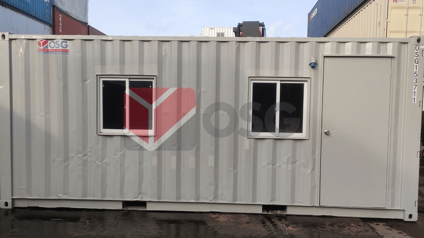 A shipping container with two windows and a door.
