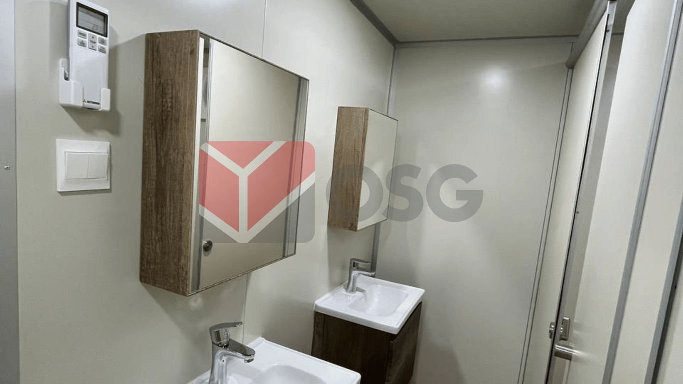 Modern bathroom with two sinks and a large mirror.