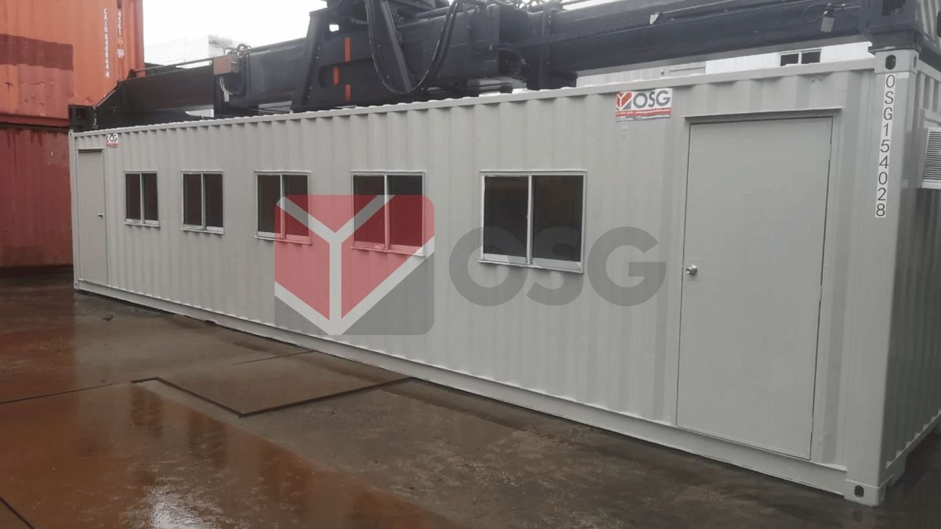 A gray shipping container with multiple windows and doors.