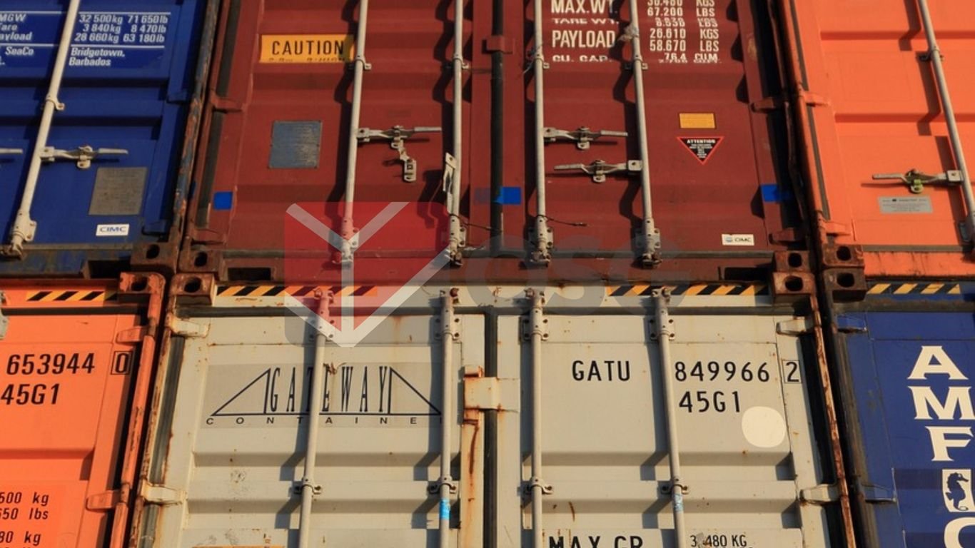 Stacked shipping containers in various colors and labels.