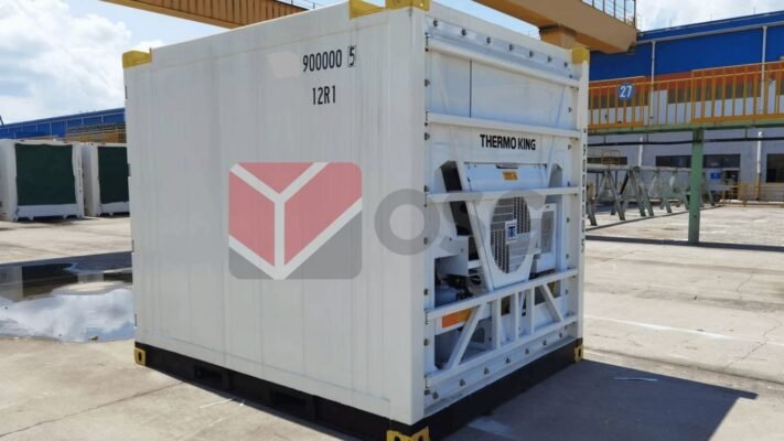 Refrigerated container with industrial branding in a storage area.