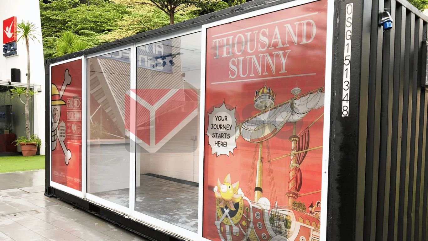 A shipping container with vibrant graphics of a ship and text.