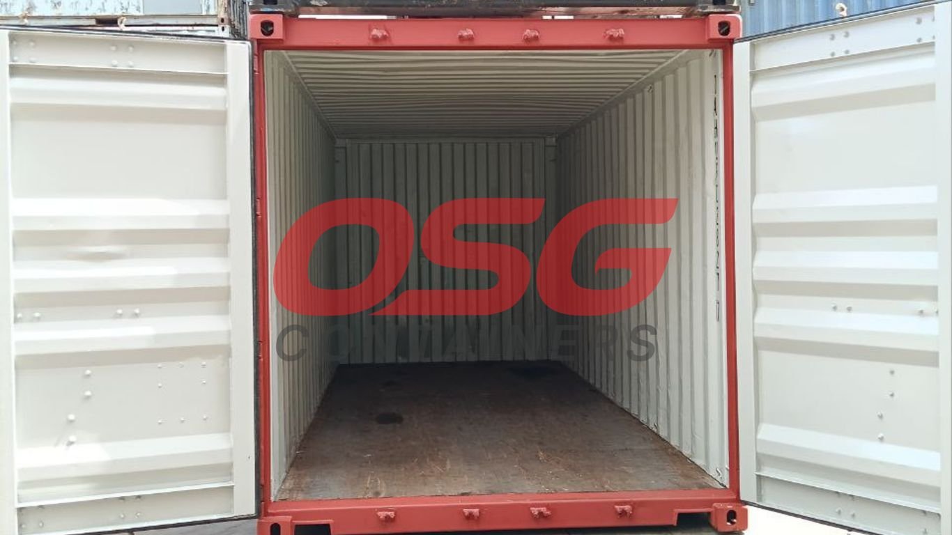 Open red shipping container with a wooden floor and white interior.