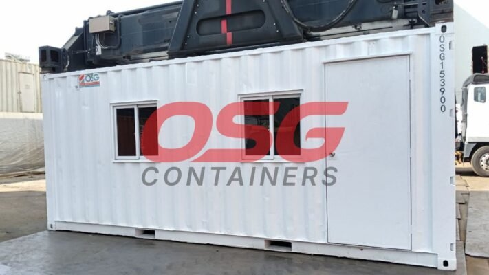 White shipping container office with windows and a door.