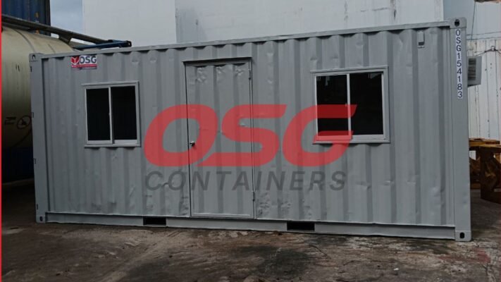 A gray shipping container modified into a small office space.