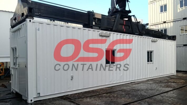 A crane lifts a white container with OSG Containers logo.
