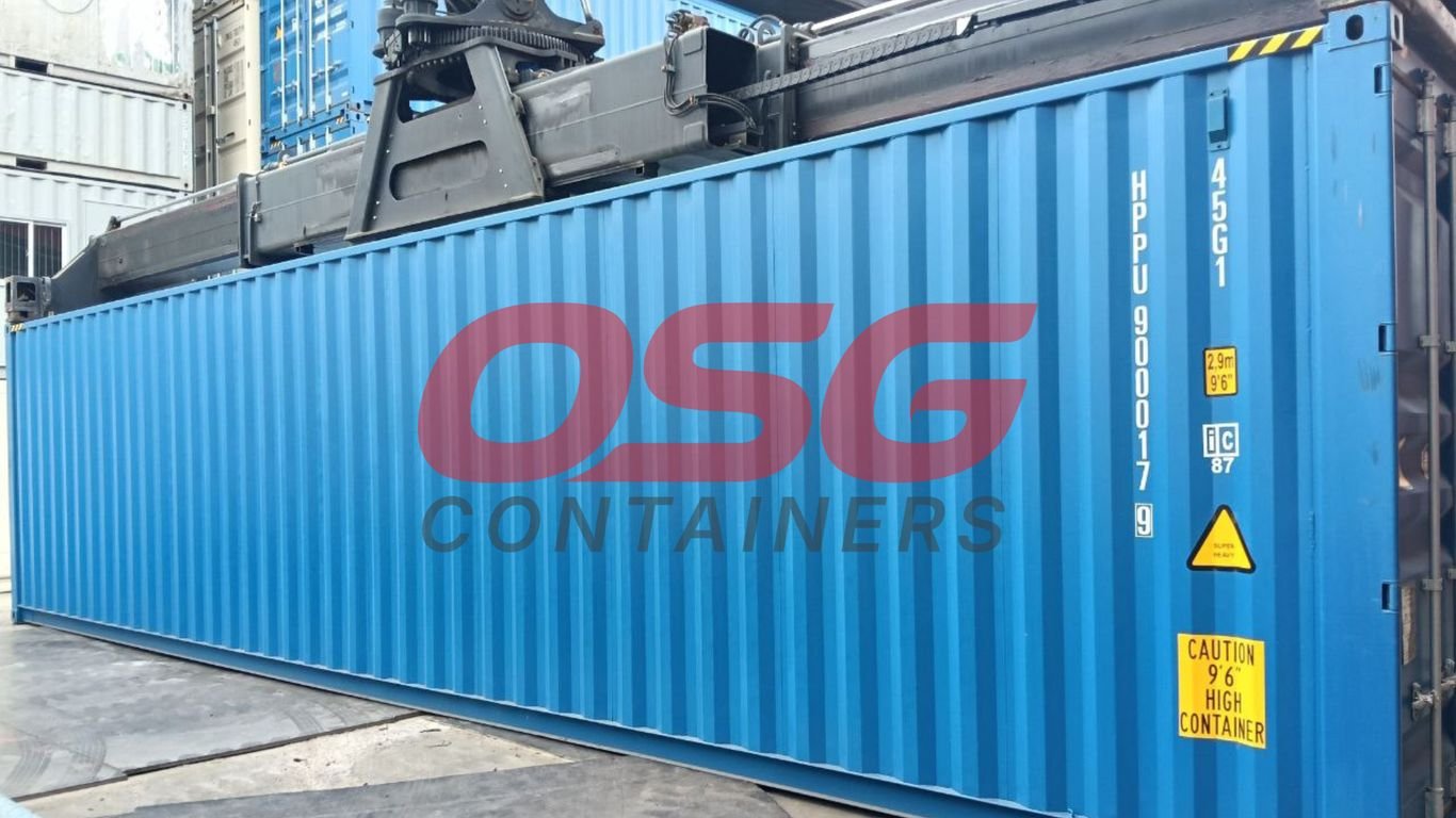 A blue shipping container with OSG Containers logo is being moved.