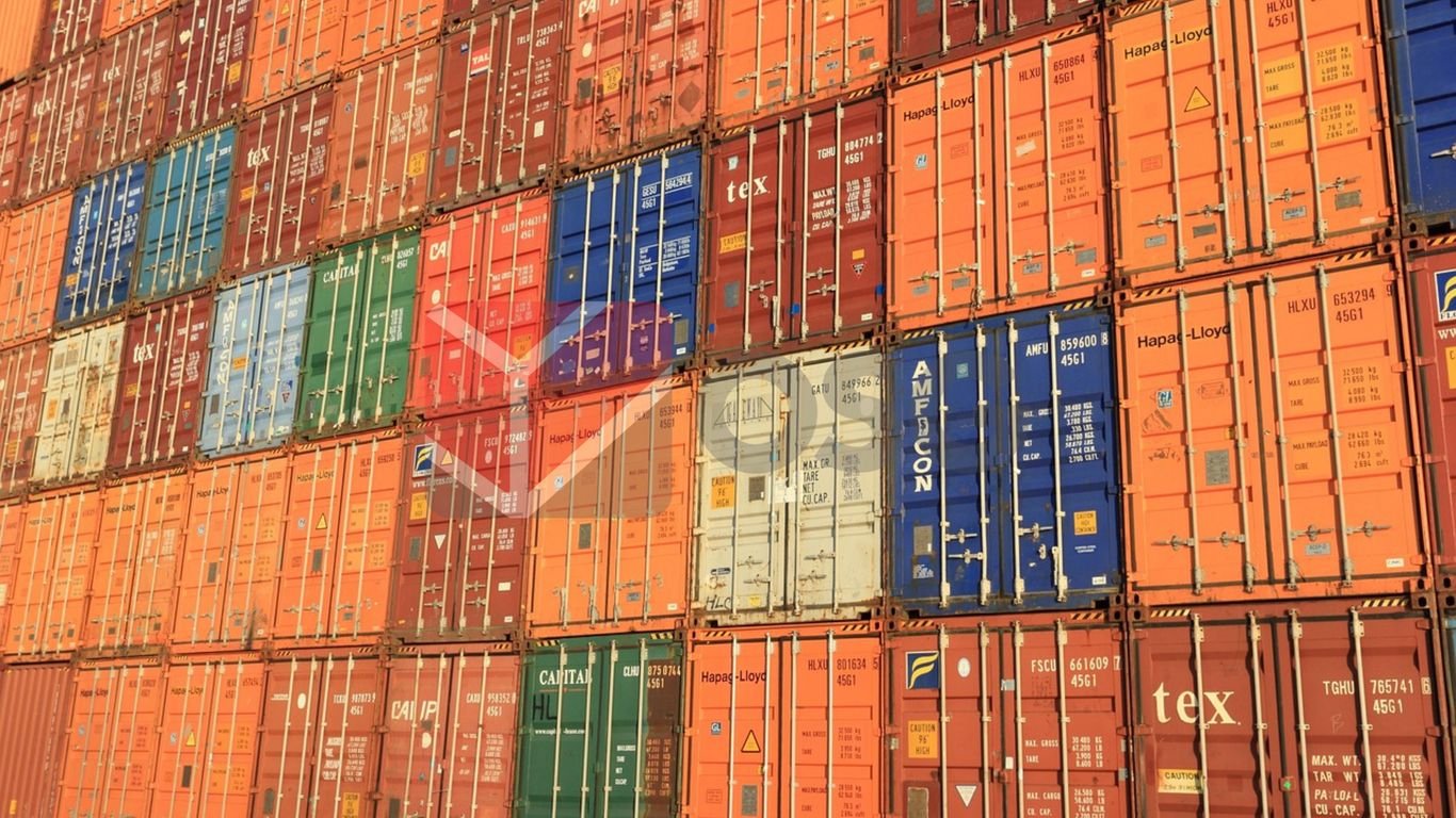 Colorful shipping containers stacked closely together in a port.