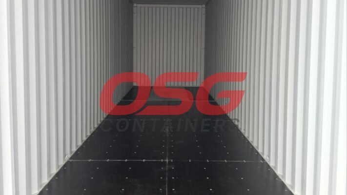 Inside view of an empty shipping container with a logo.