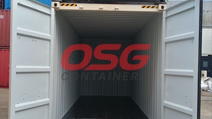 Empty shipping container with doors open, showing interior.