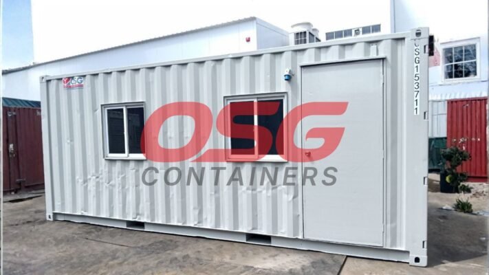 A modified shipping container with windows and a door.