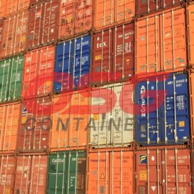 A wall of stacked shipping containers in various colors.