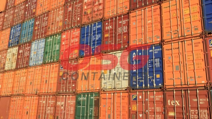 A wall of stacked shipping containers in various colors.