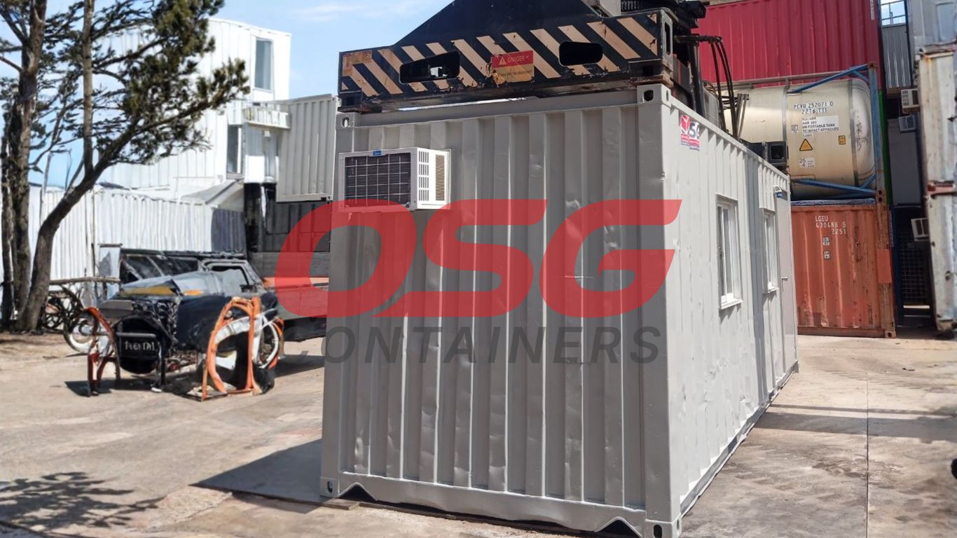 Shipping containers are stacked and arranged in an outdoor lot.