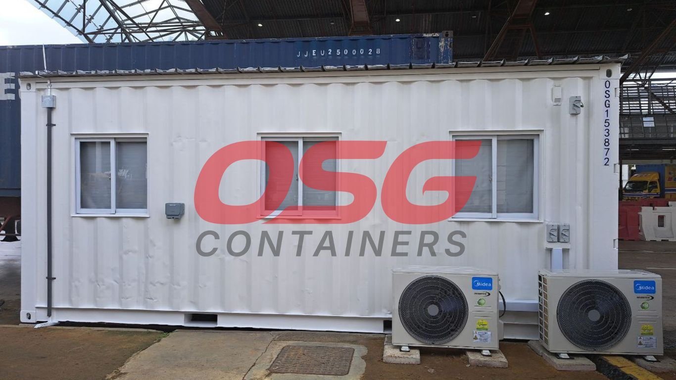 White shipping container office with windows and air conditioners.