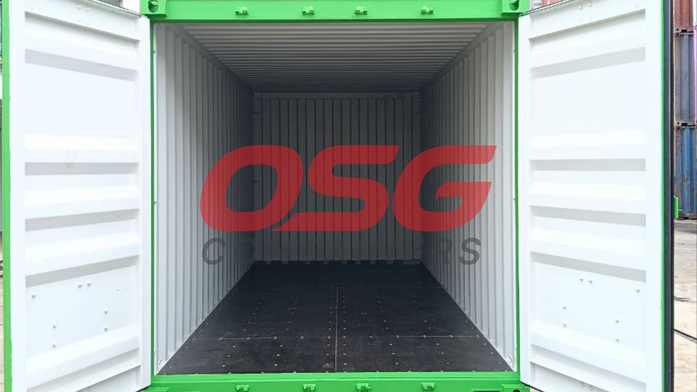 Empty green shipping container with doors open, showing interior.