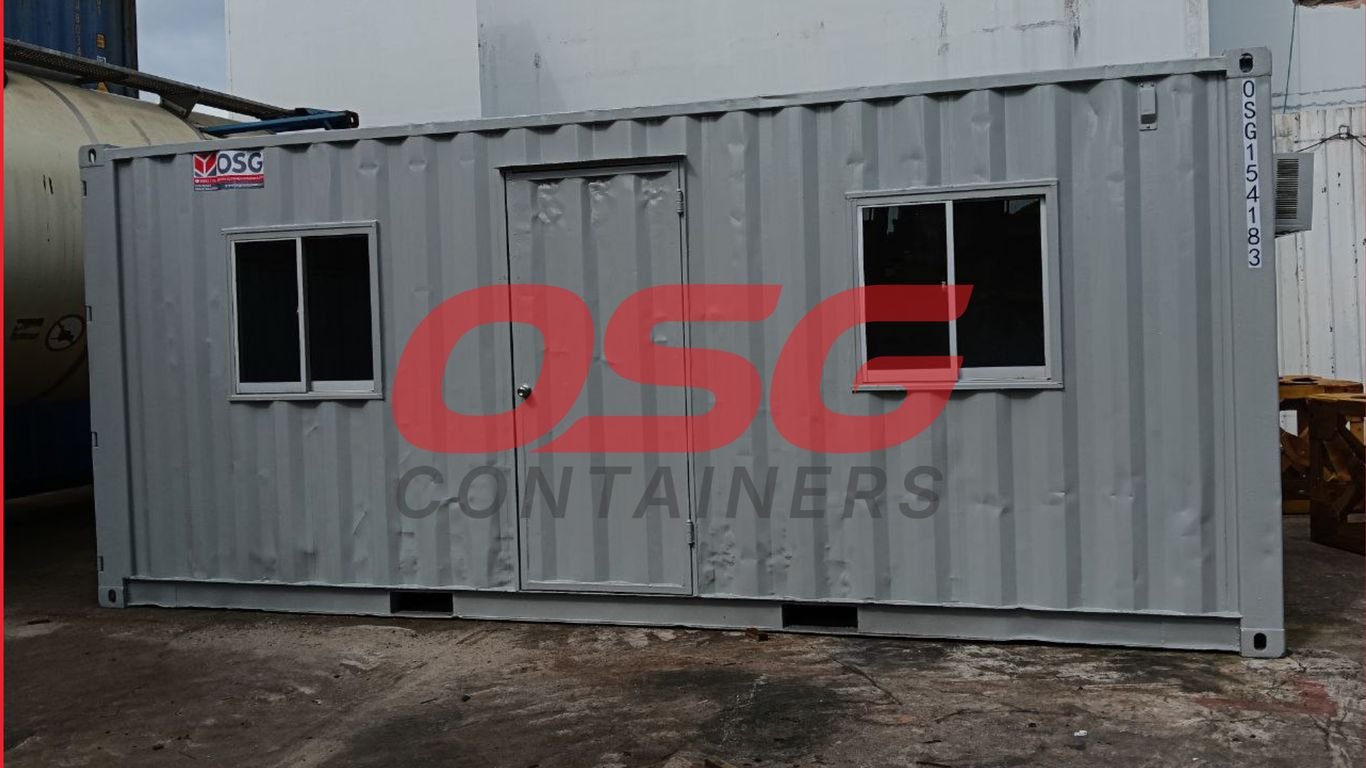 A gray shipping container modified into a small office space.