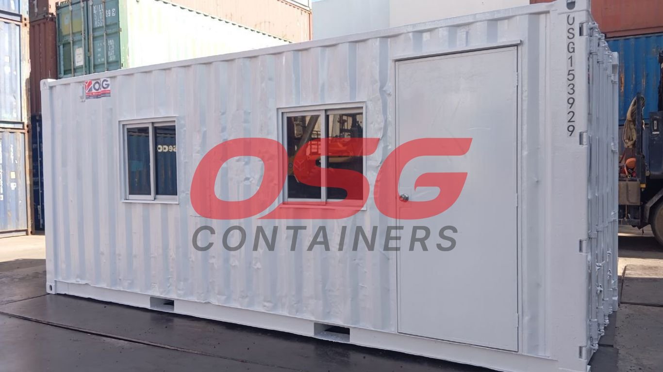 White shipping container office with windows and door.