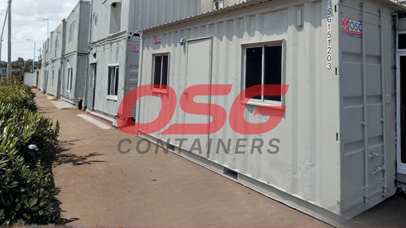 Row of modular shipping container offices with windows and doors.