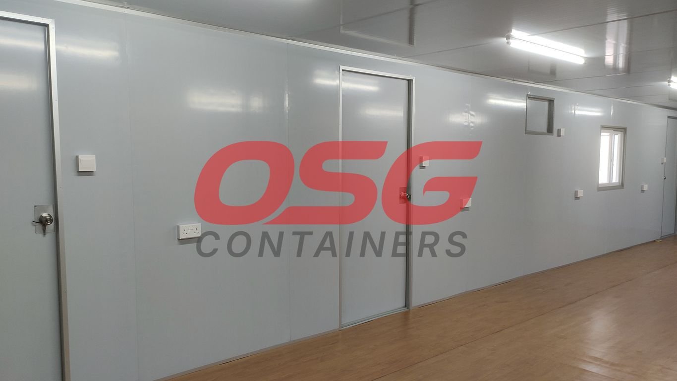 Interior of a modular container unit with doors and windows.