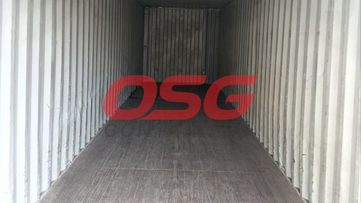 Inside view of an empty shipping container with corrugated walls.