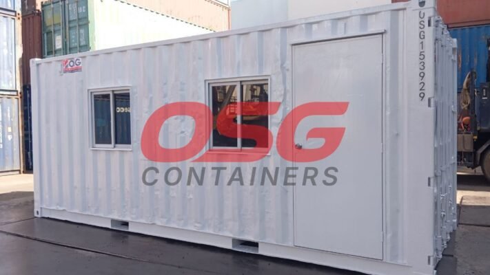 White shipping container office with windows and door.