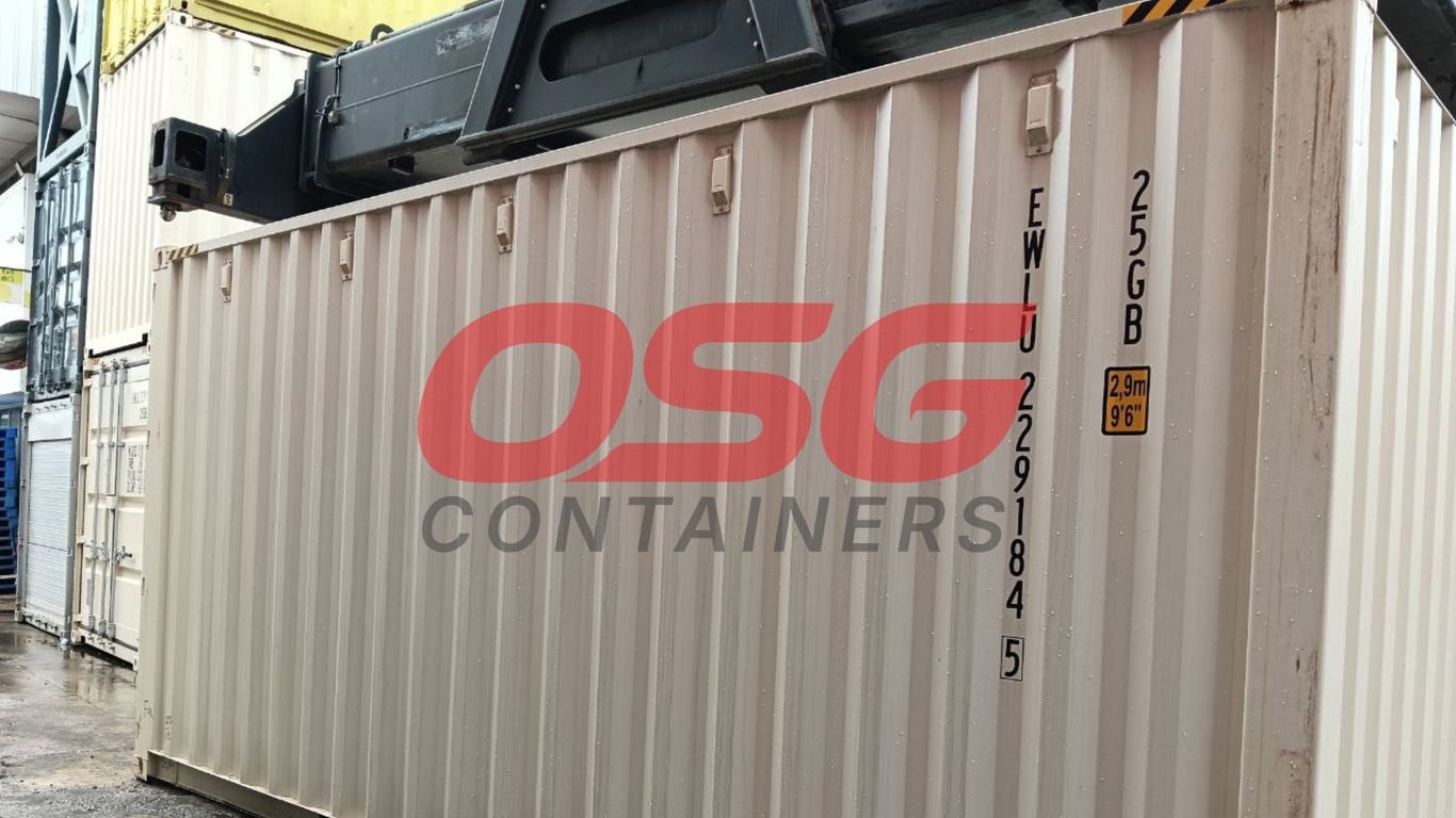 Shipping containers stacked at a yard with a crane overhead.