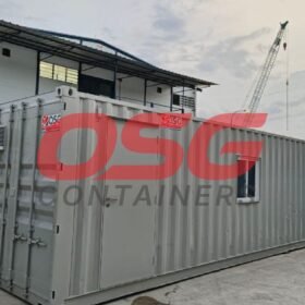 Shipping container converted into a small office with air conditioning units.