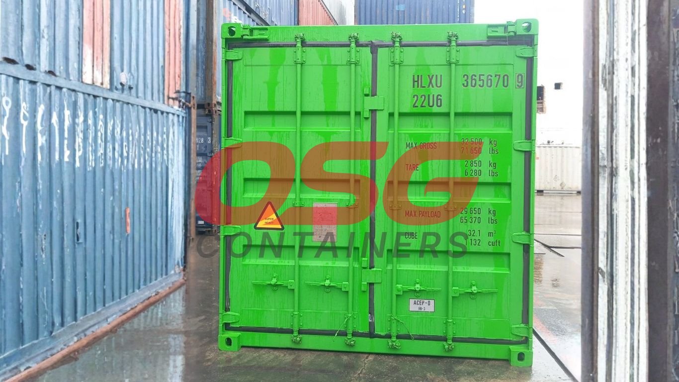 A bright green shipping container is shown in a yard.