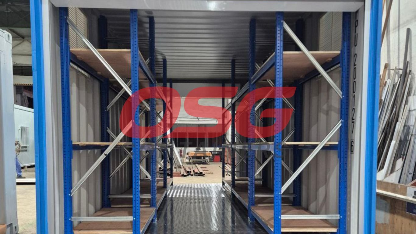 Interior of a shipping container with shelving units.