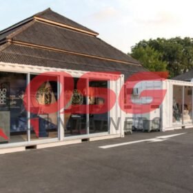 Shipping containers converted into shops with glass fronts.